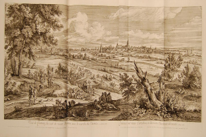 Offenes Buch mit der Aufschrift 'Ansicht der Schlacht von Castellum und Castellium aus der Illustrated London News', das eine Landschaftsillustration mit Menschen in der Vordergrund, Bäumen, Pflanzen, Gebäuden im Hintergrund und Wolken am Himmel zeigt.