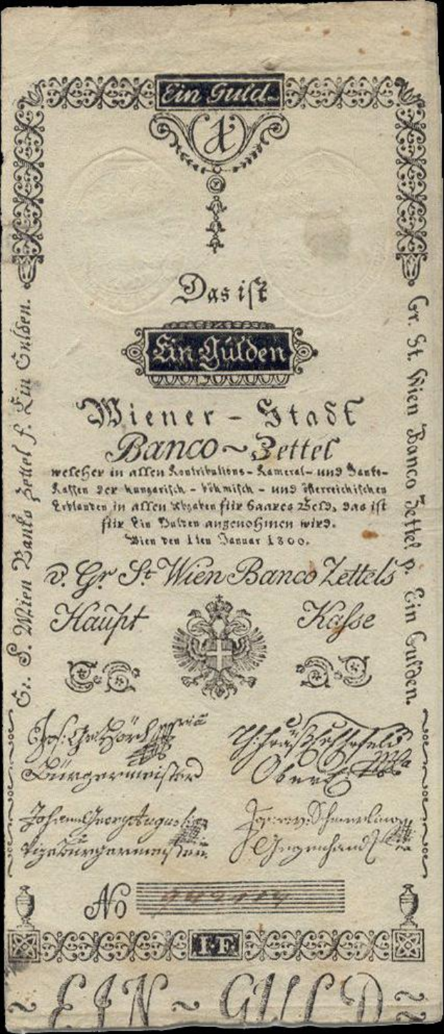 Eine alte deutsche Banknote mit einem schwarzen Hintergrund, die das Gesicht eines Mannes und den Text "St. Wien - Stäse Banco-Settel" zeigt.