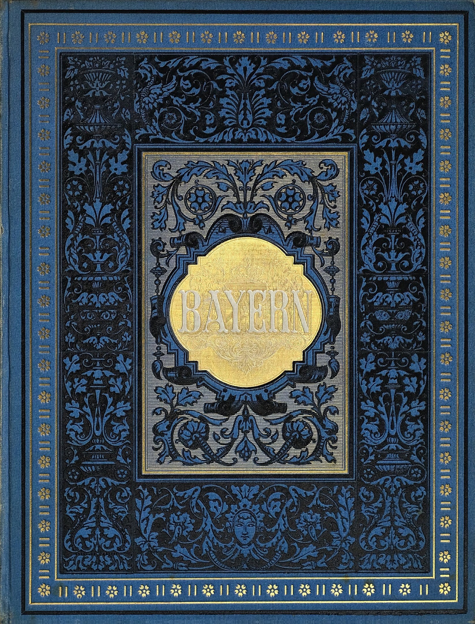 Ein blau-goldenes Buch mit dem Wort "Bayern" auf seinem kunstvoll gestalteten Deckel.