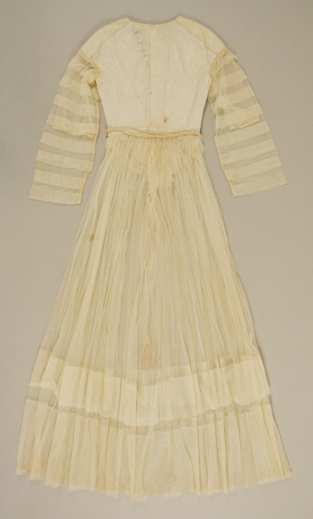 Ein weißes Langarmkleid mit einer gerüschten, voluminösen Röcke auf einer weißen Oberfläche, mit einem hohen Taillenbund, bodenlanger Saum und dezentem Schimmer.