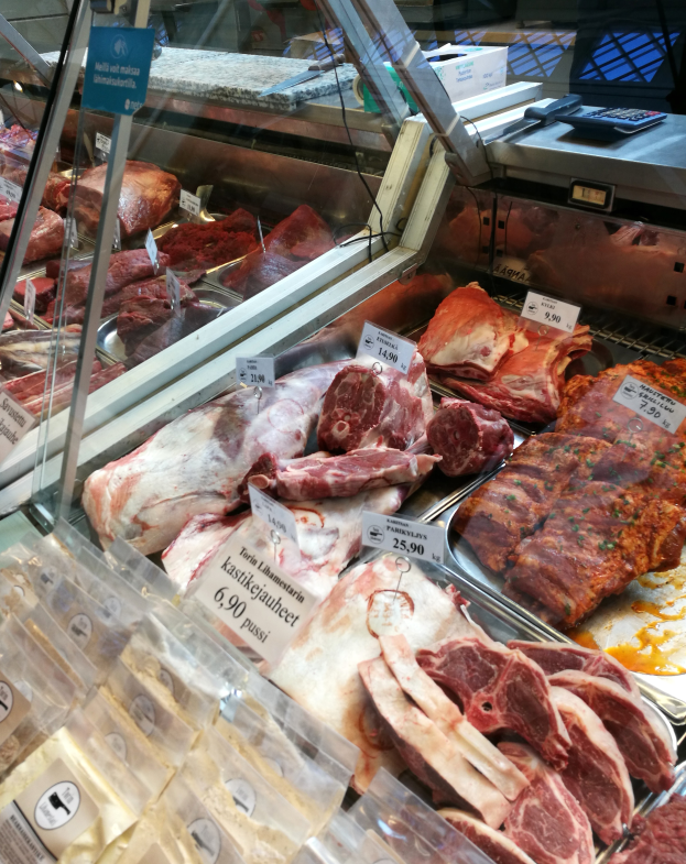 Eine Fleischtheke mit verschiedenen Fleischsorten, jede mit einem Preisschild versehen.