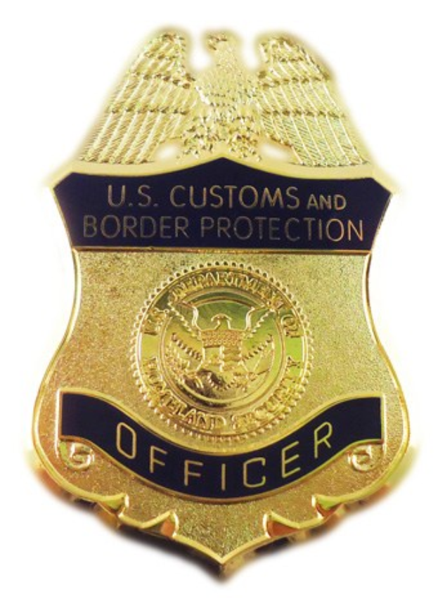 Goldabzeichen mit dem Text "U.S. Customs and Border Protection Officer" auf einem weißen Hintergrund.